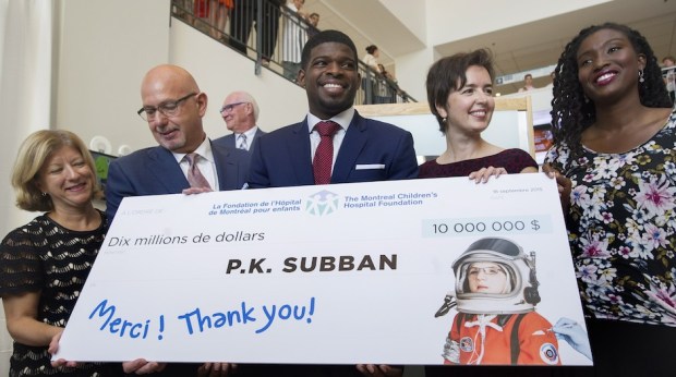 Montreal Canadiens defenceman P.K. Subban, centre, smiles as he poses for the cameras following a press conference at the Children's Hospital in Montreal, Wednesday, September 16, 2015, where he announced that his foundation would pledge $10-million to the hospital. THE CANADIAN PRESS/Graham Hughes